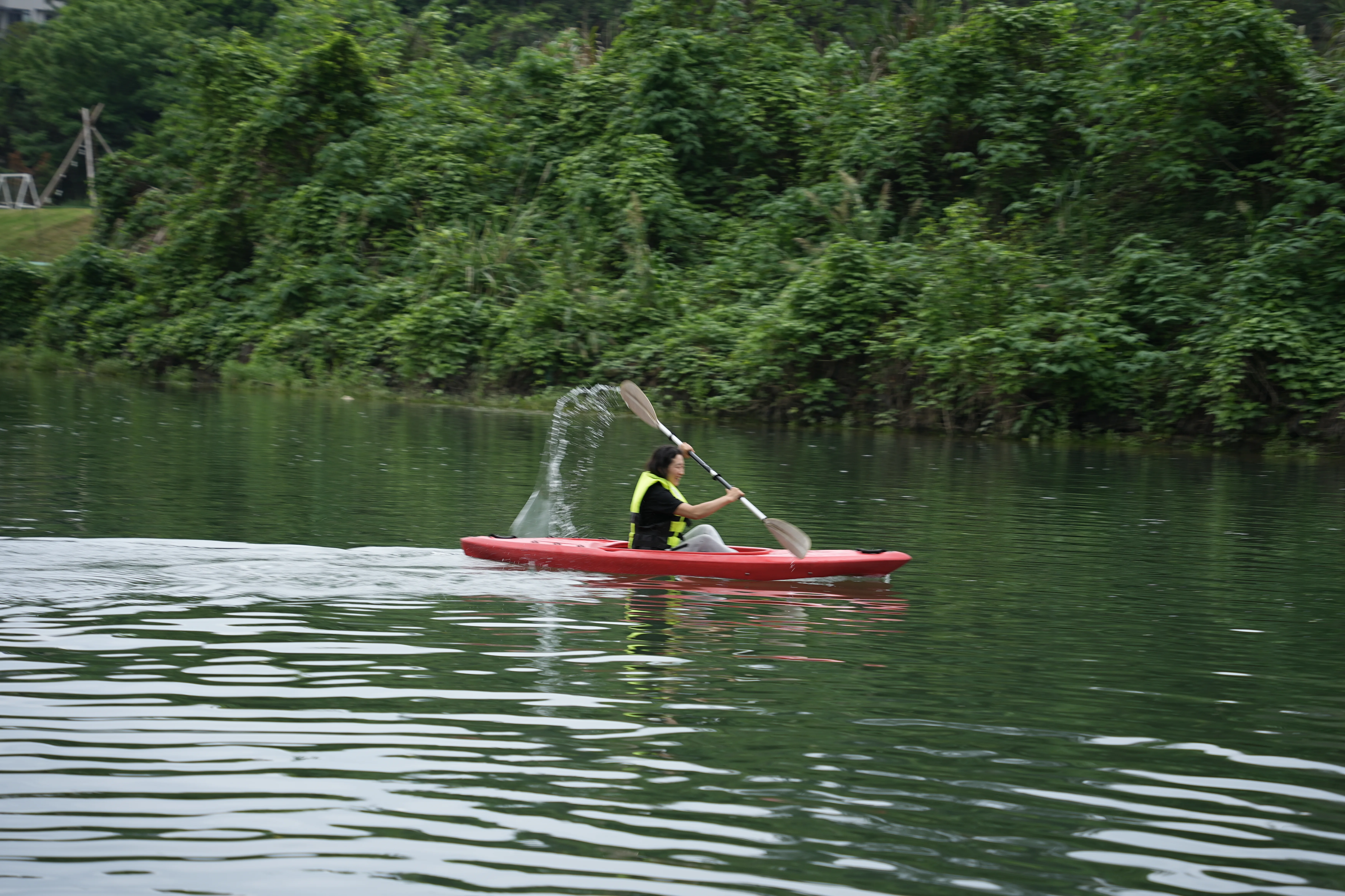 Aerial view of participants in life jackets on the water with natural jungle river, China