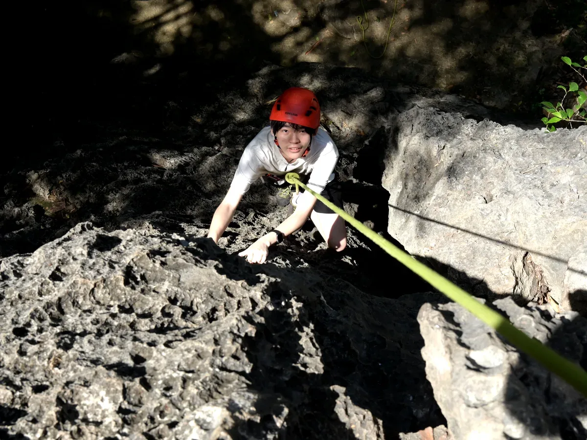 Happy climber giving a thumbs up on the outdoor limestone crag in China