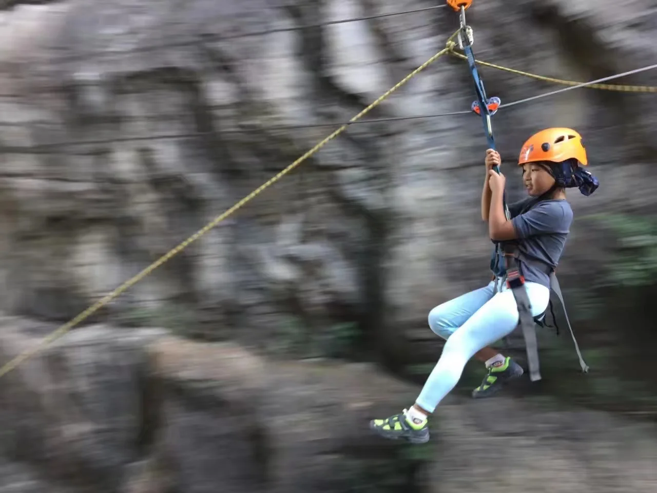 Group of participants gearing up with helmets and harnesses at the via ferrata start point in China