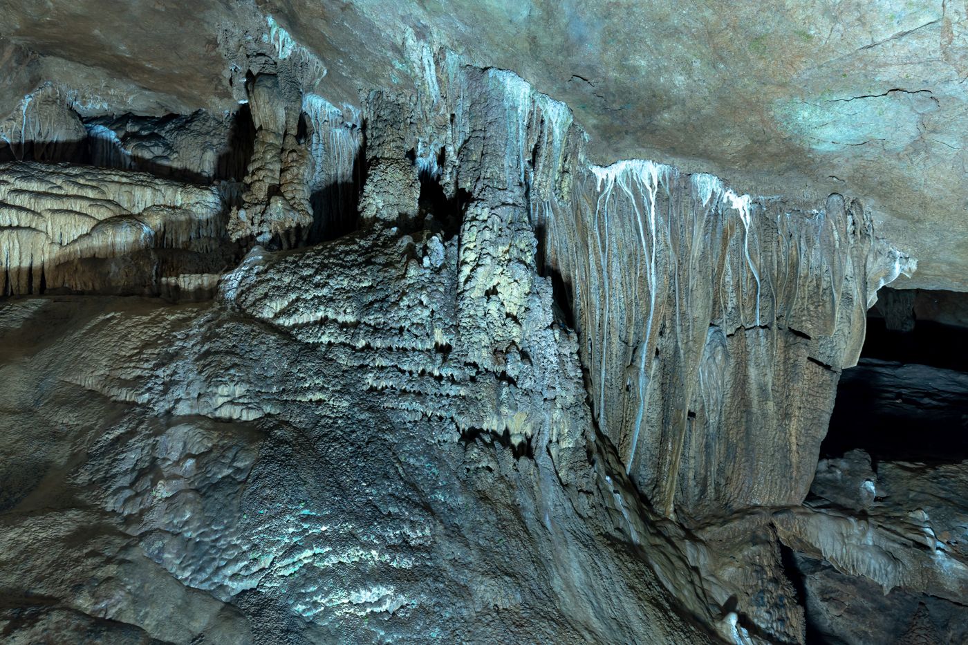 Lit cave with stalactites and stalagmites in Guizhou