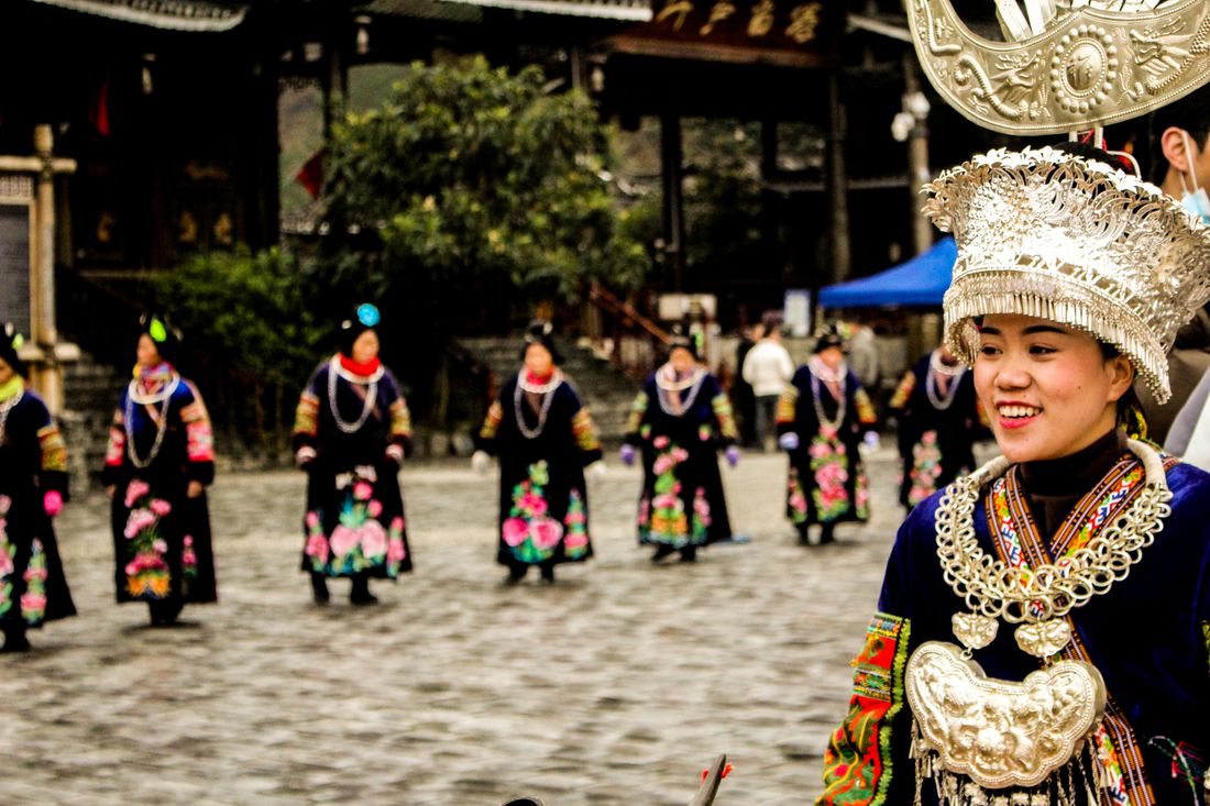 Miao women in traditional attire at a festival, Guizhou