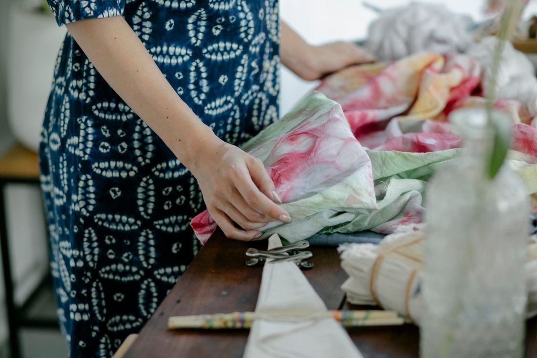 Woman crafting tie-dye textiles in Hangzhou workshop